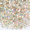 A close-up view of a mix of clear and iridescent glass rhinestones for DIY crafts.