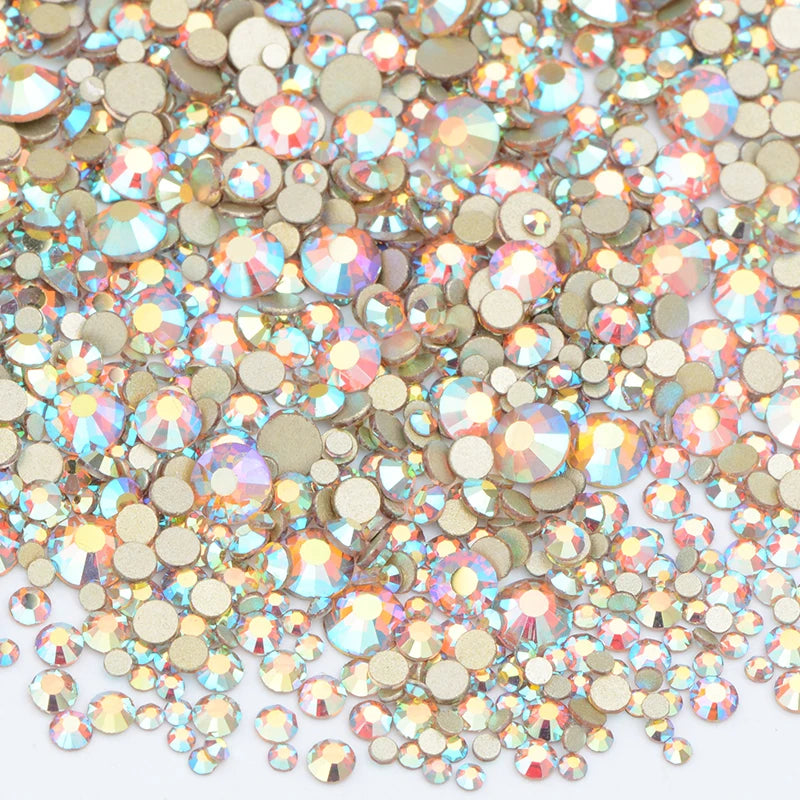 A close-up view of a mix of clear and iridescent glass rhinestones for DIY crafts.