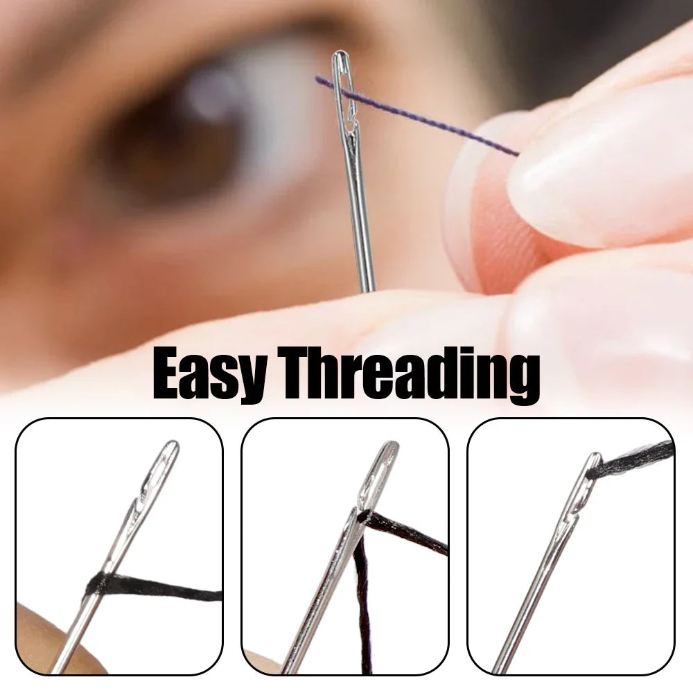 Close-up of a hand threading a black thread through a stainless steel sewing needle for easy threading.