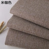 Close-up of coarse linen and cotton fabric in a beige or brown color, showing the woven texture.