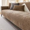 A tan chenille sofa cushion cover with gray and brown accent pillows on a light-colored sofa.