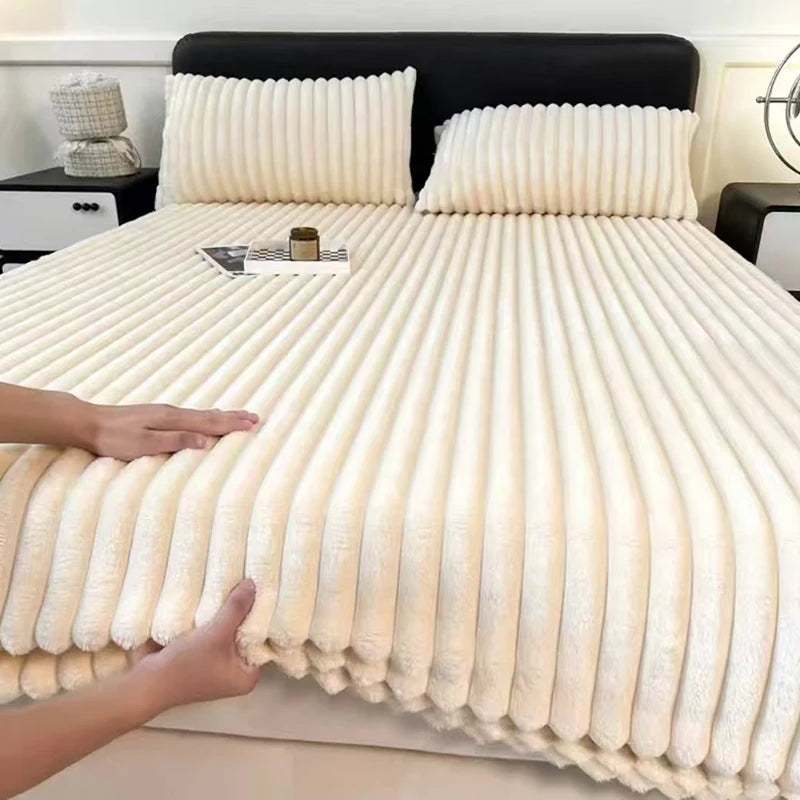 A close-up of thick, cream-colored winter fitted bed sheets with vertical pleats on a bed.