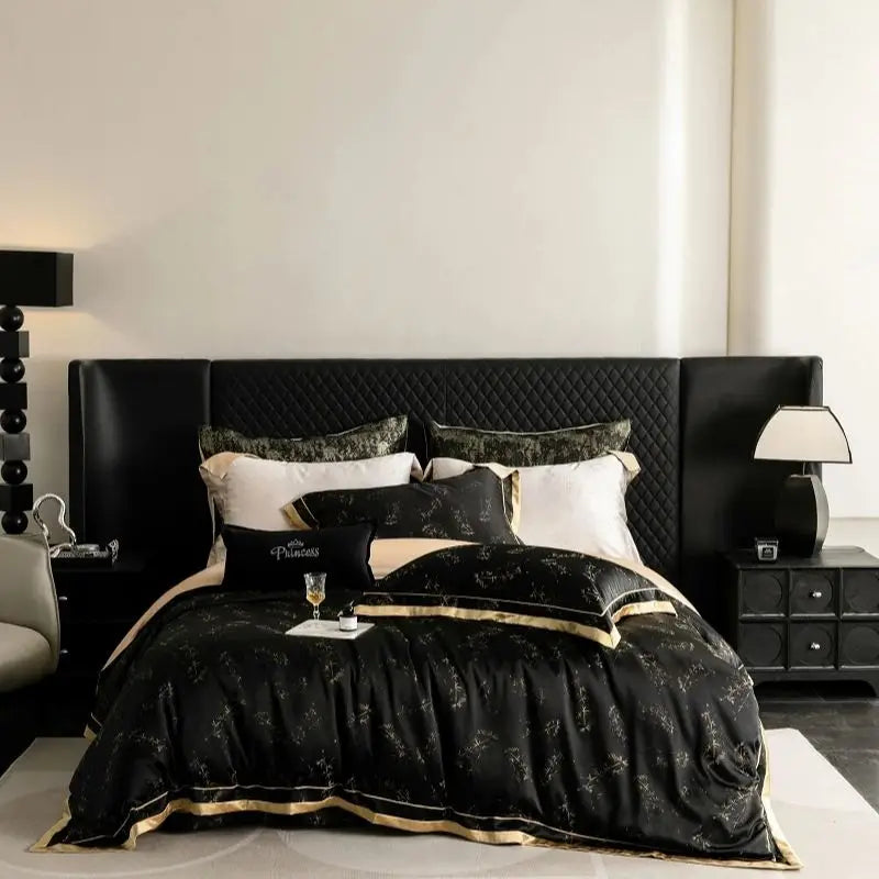 A black and gold luxury bedding set featuring a quilted duvet on a bed with dark wood nightstands.