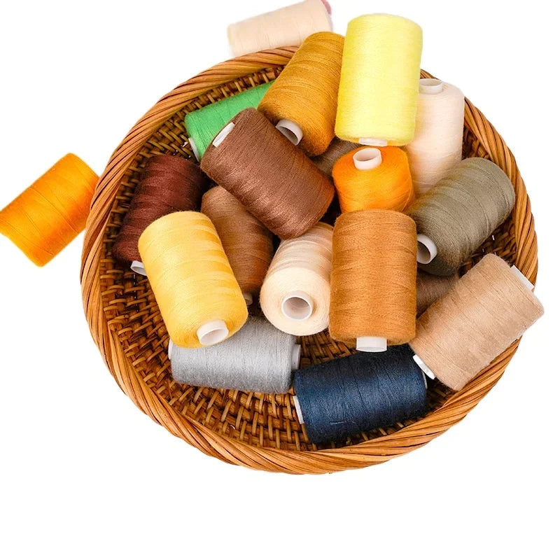 A collection of ten rolls of various colored polyester sewing thread arranged in a woven basket.