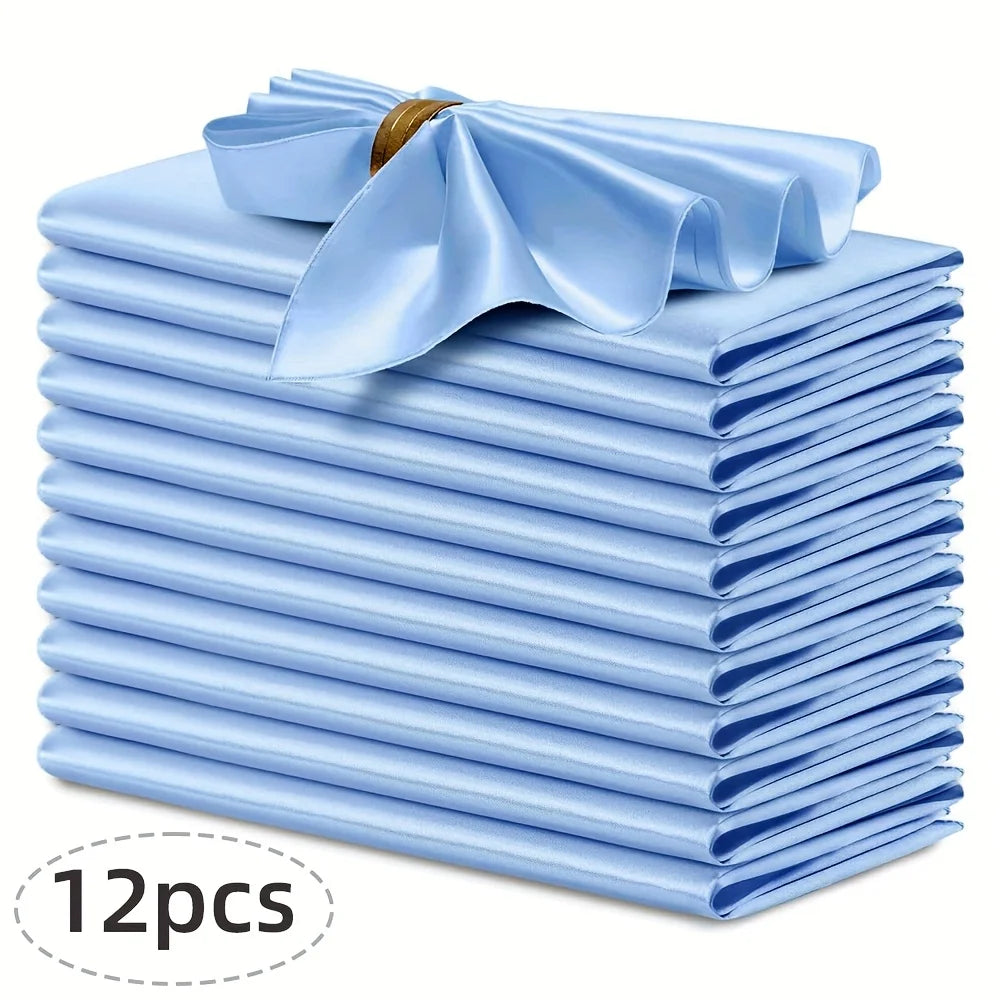 A stack of twelve light blue silky satin dinner napkins with a decorative bow on top.
