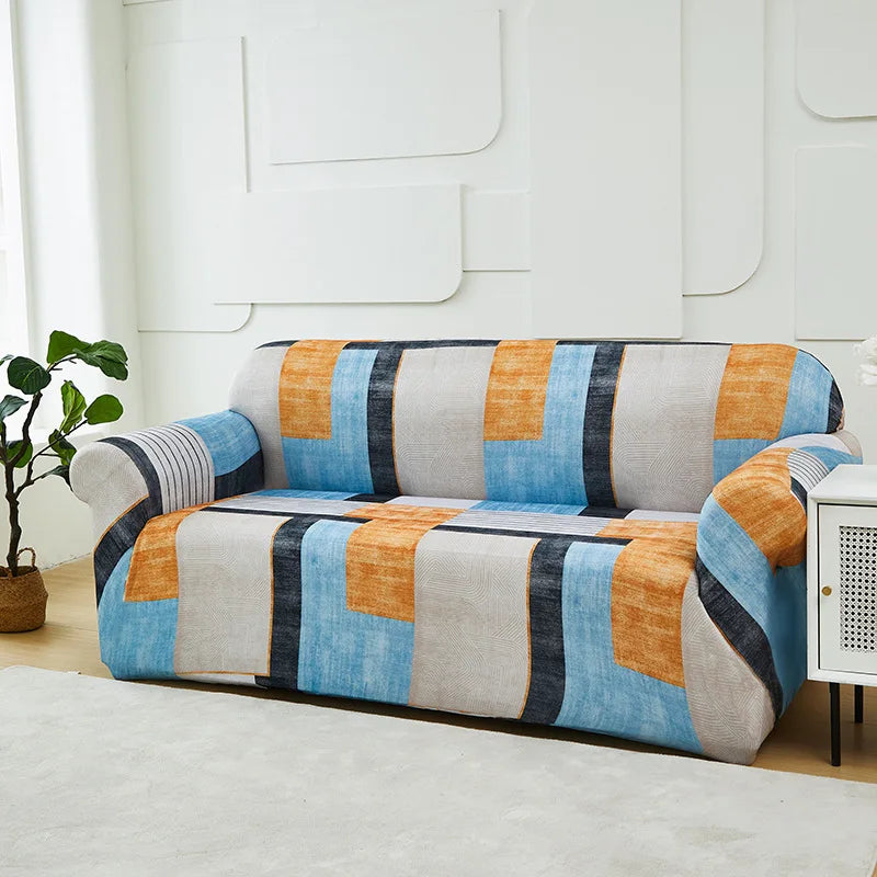 A modern sofa and chair slipcover featuring a patchwork design in shades of blue, orange, gray, and black.
