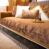 A luxurious bed featuring a brown patterned velvet cover, white pillows, and gold accents in a modern room.