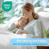 A mother gently holds a sleeping baby while lying in luxury bedding, emphasizing healthy and happy with OEKO-TEX certified dy
