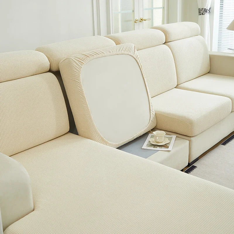 A light beige jacquard elastic sofa cushion slipcover on a modern sectional sofa.