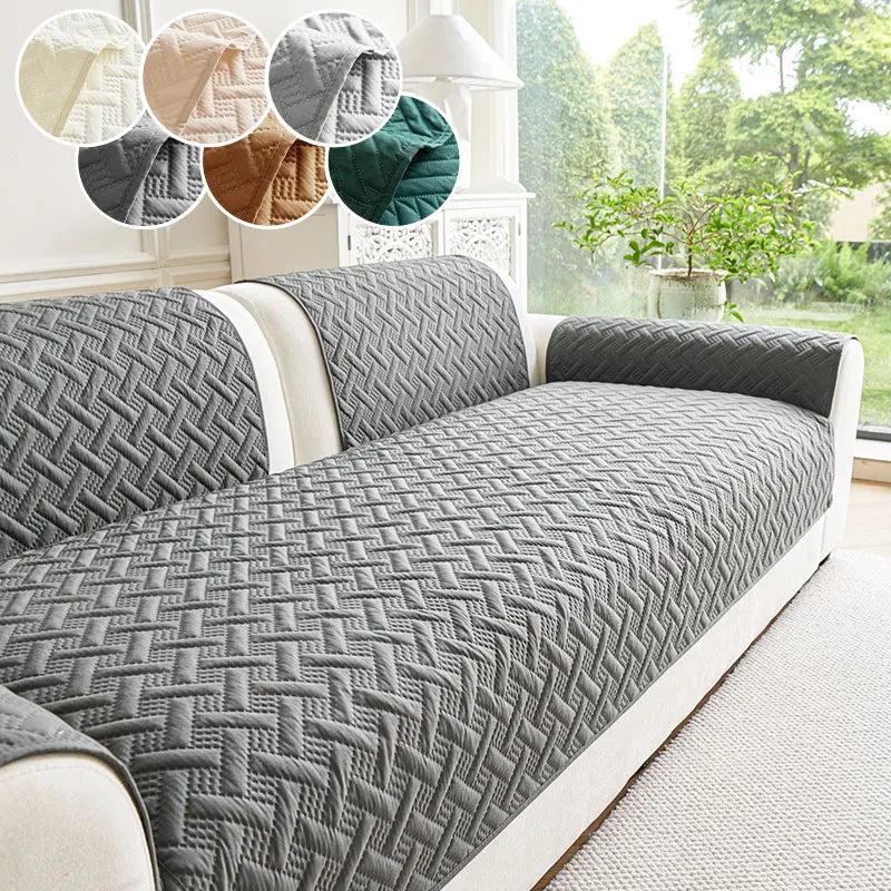 A gray quilted sofa cushion with a diamond pattern displayed on a white sofa.