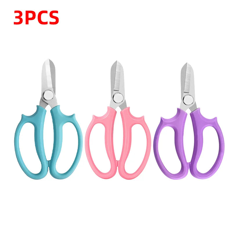Three pairs of precision floral and bonsai shears in various colors including silver, teal, pink, and purple.