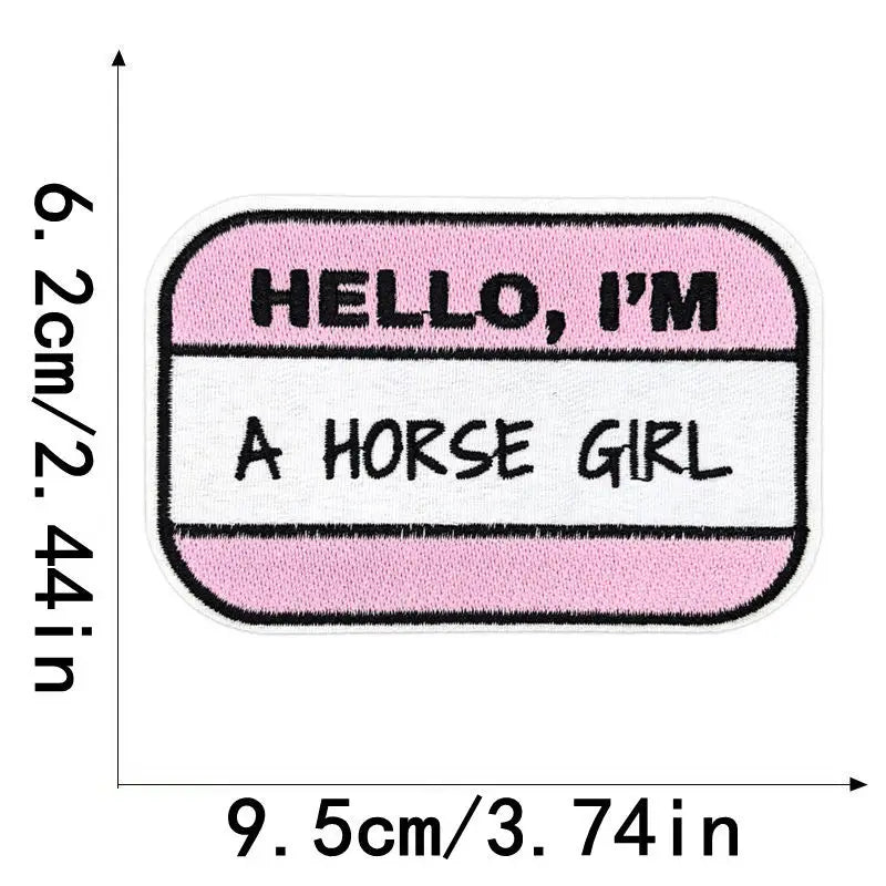 A pink and white rectangular embroidered patch with the text HELLO I'M A HORSE GIRL