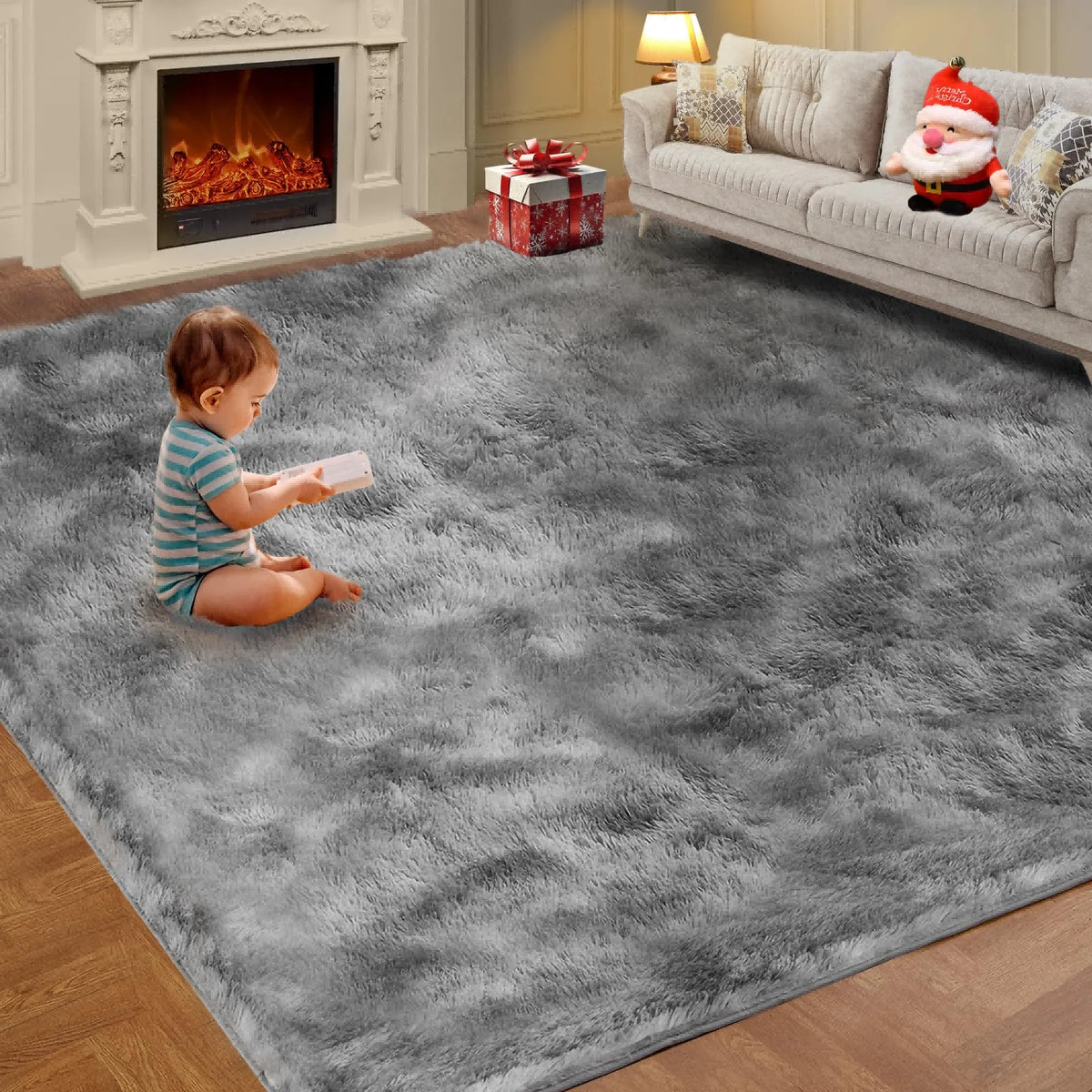 A fluffy gray living room rug with a festive red and white Christmas decoration sits on a wooden floor.