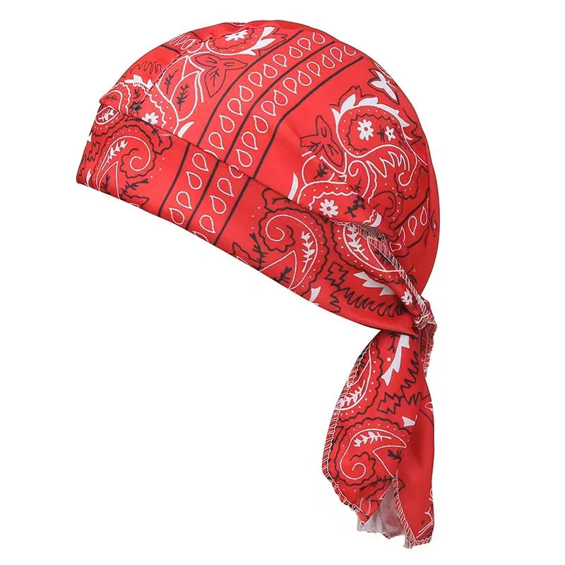 A red paisley print unisex headwrap folded and displayed against a white background.
