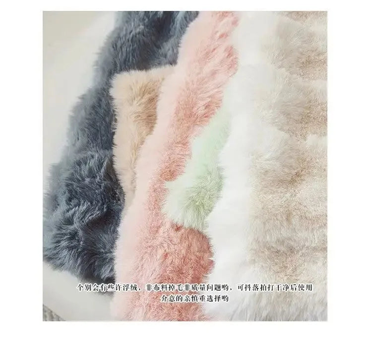 A close-up of a plush winter throw pillow cover featuring soft, fluffy faux fur in shades of gray, pink, and beige.
