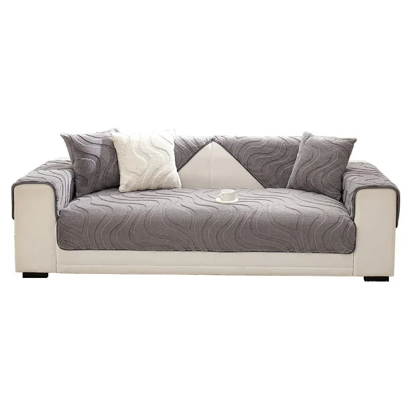 A light gray sofa with textured cushions and a white accent cushion.