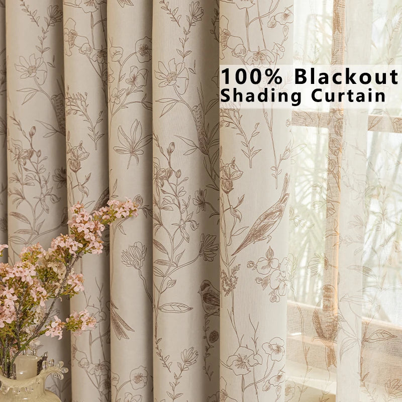 Close-up view of beige blackout shading curtains with a subtle floral pattern hanging in a window.