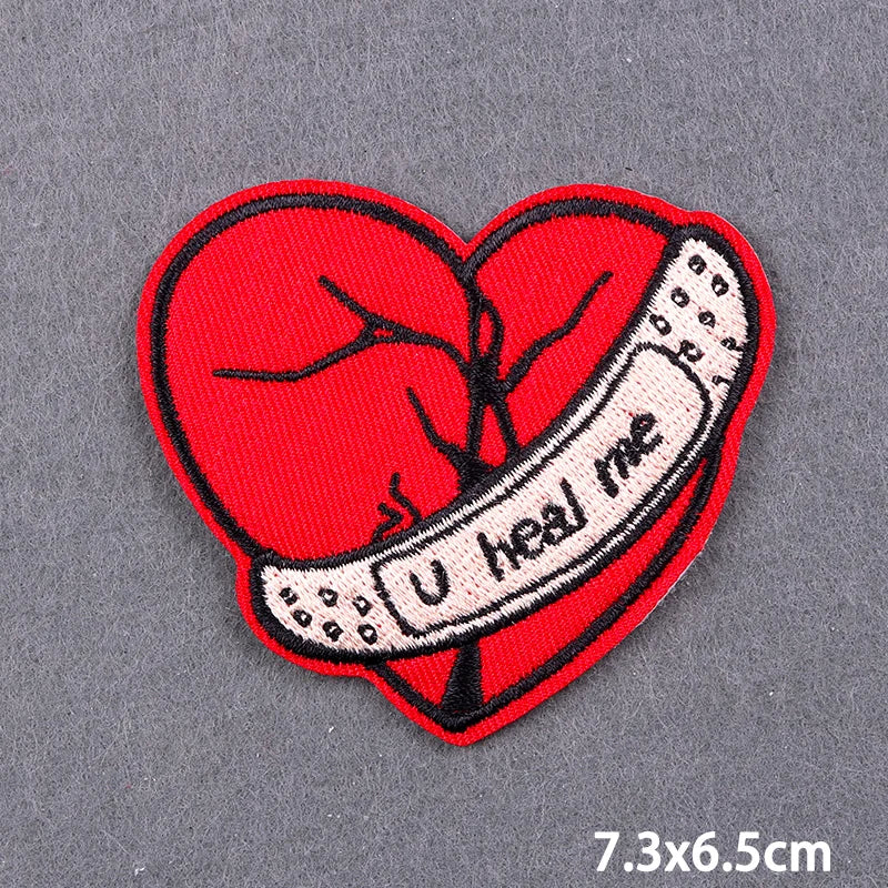 Red heart embroidery patch featuring a stylized heart and the text I heal me on a gray background.