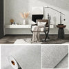 A close-up view of self-adhesive 3D thermal insulation wallpaper with a linen texture in light gray.