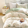Elegant floral tea art duvet cover set featuring white and sage green patterned bedding.