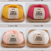 A collection of natural colored organic cotton yarn skeins labeled Cotton-29 through Cotton-34 displayed on wooden trays.