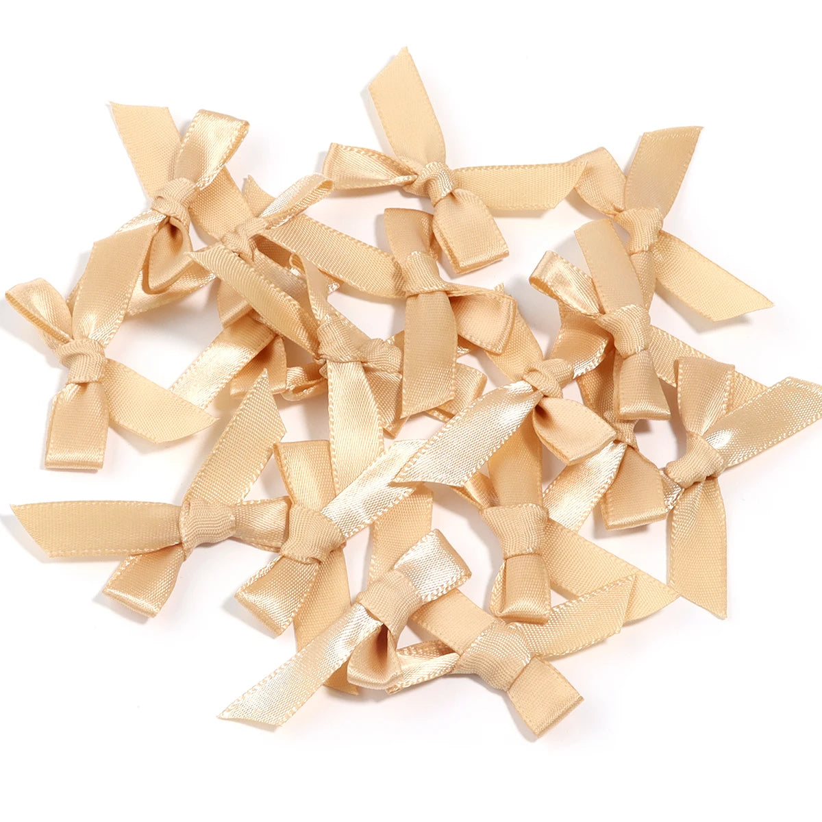 A collection of light beige satin ribbon bows for craft and decoration.
