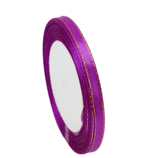 Roll of 6mm gold-edged satin ribbon in vibrant purple for gift wrapping and crafts