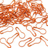 A pile of orange safety bulb pins for knitting and sewing.