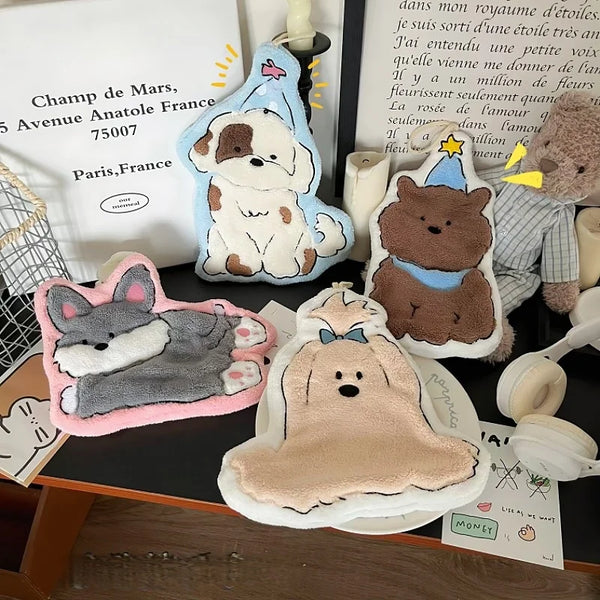 A collection of cute cartoon dog-themed hanging hand towels and decorative items.