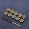 A set of small, round, decorative metal snap buttons arranged on a dark blue fabric background.