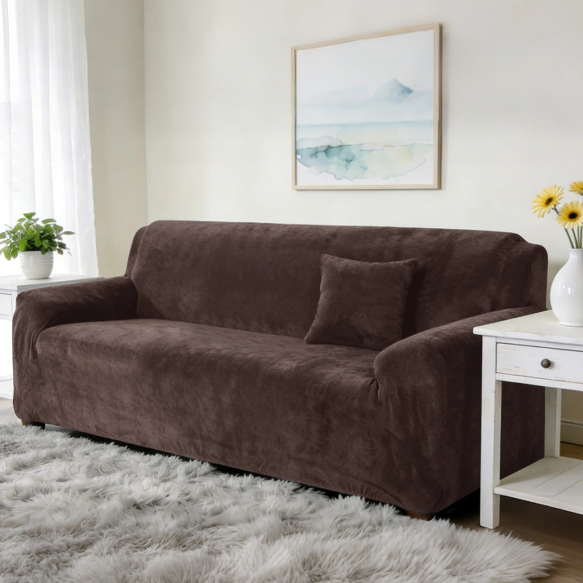 A dark brown stretch velvet sofa slipcover resting on a light gray fluffy rug in a bright room.