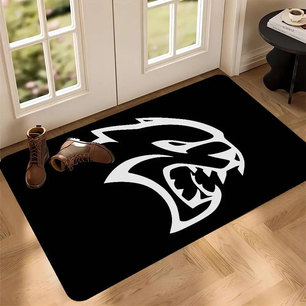 Black door mat featuring a white stylized lion head design on a light wood floor.