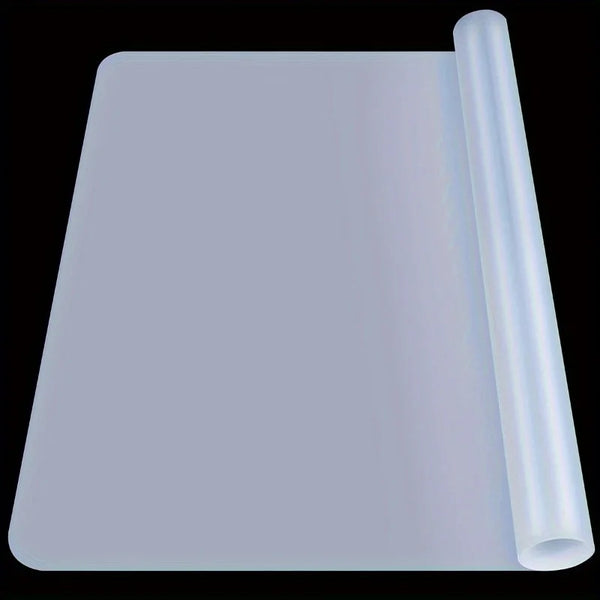 A translucent silicone crafting mat with a cylindrical tool or guide resting beside it.