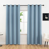 A set of two modern light blue blackout grommet curtains hanging in a window frame.