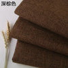 Stack of dark brown coarse linen or cotton fabric rolls