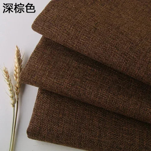 Stack of dark brown coarse linen or cotton fabric rolls