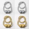 A set of four magnetic curtain tiebacks in silver and gold tones, shown against a white background.