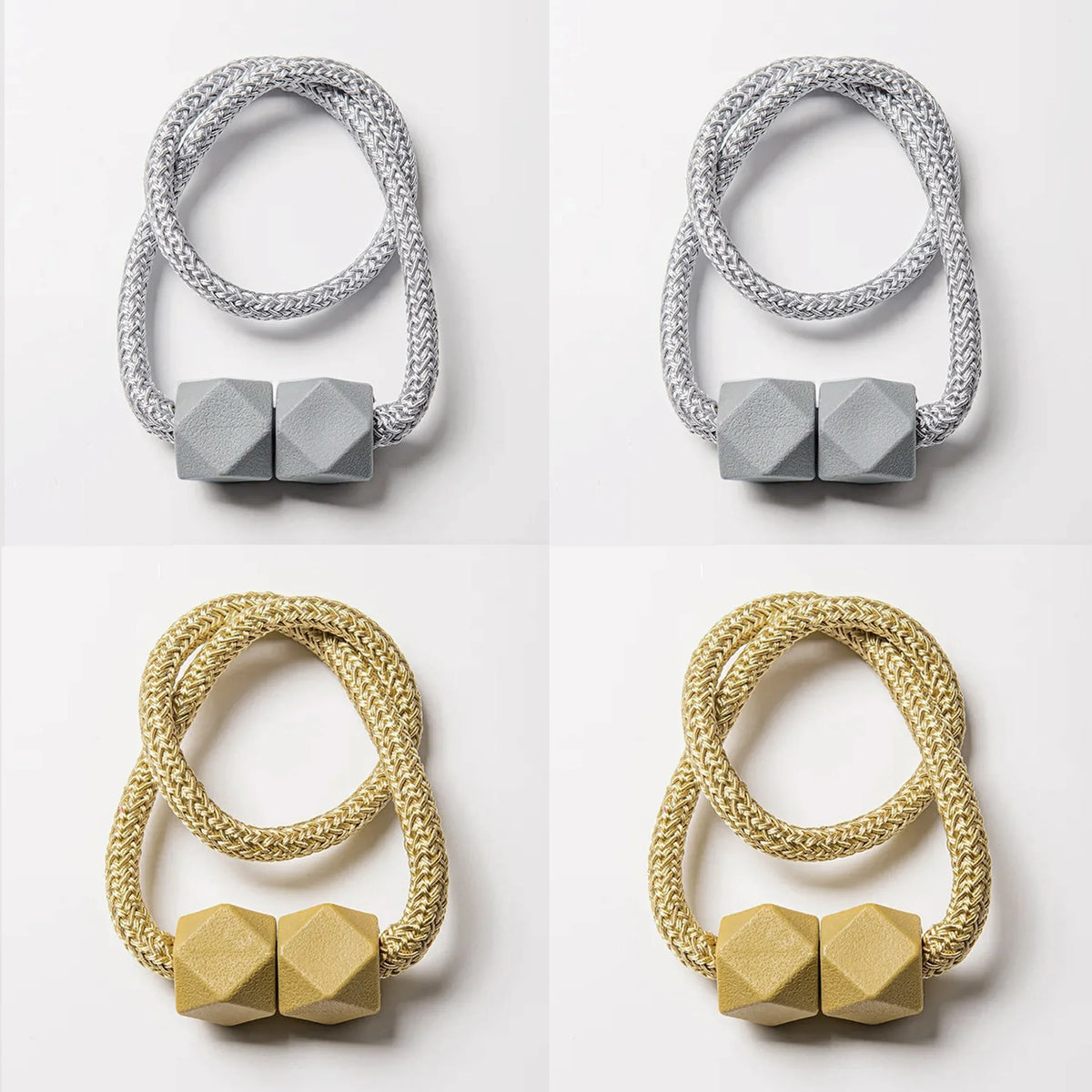 A set of four magnetic curtain tiebacks in silver and gold tones, shown against a white background.