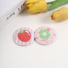 A set of funny tinplate pin brooches featuring strawberry and clover designs.