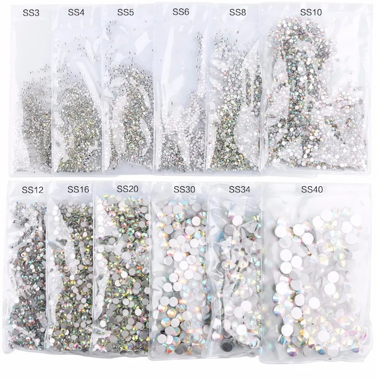 A collection of flatback rhinestones in various colors and sizes packaged in small plastic bags.