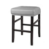 A dark wood bar stool with a gray upholstered seat and legs.