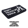 Black embroidered patch with white text that reads DON'T TOUCH MY TOOLS