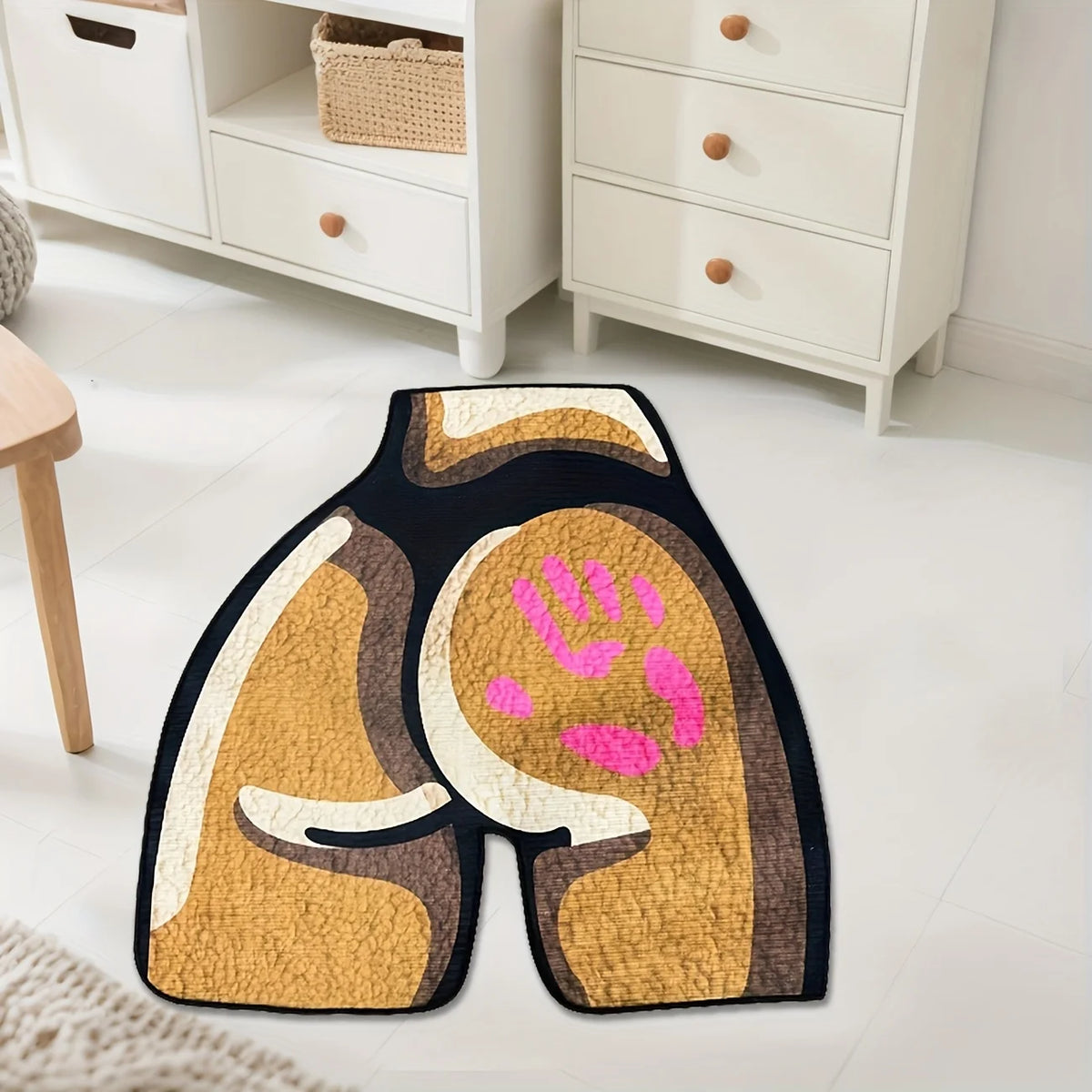 A square area rug featuring a golden-brown and black pattern with pink paw prints on a dark background.