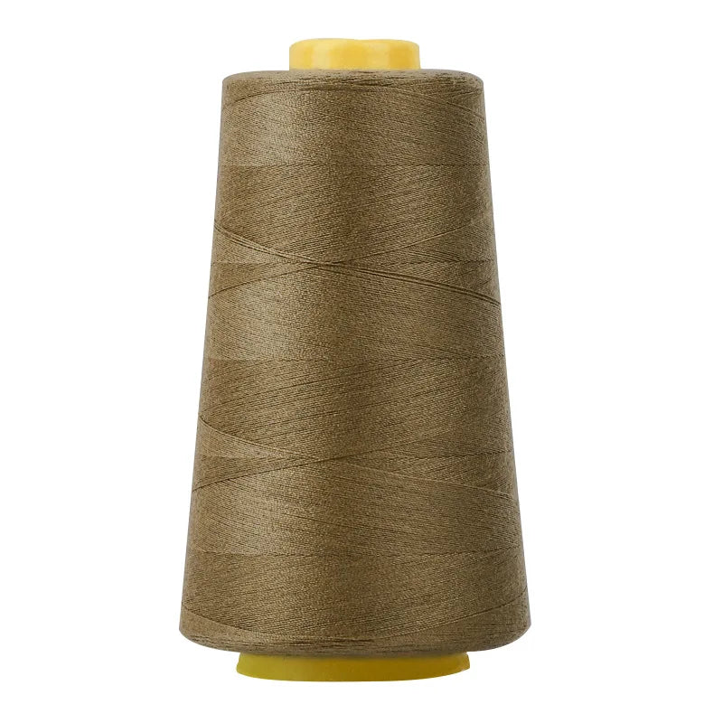A roll of brown sewing thread on a yellow spool.