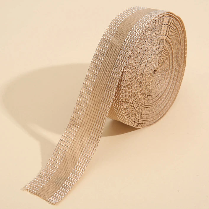 Roll of beige self-adhesive hem tape for fabric repair and shortening