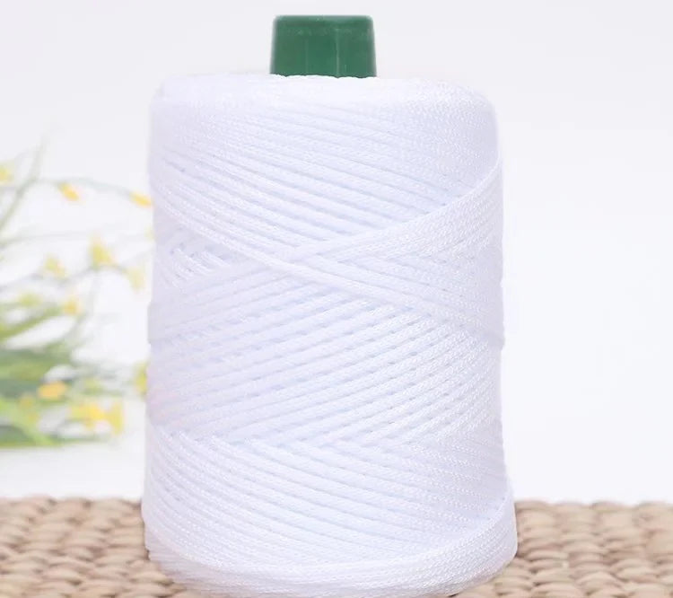 A roll of white crochet ice rope with a green cap, lying on a woven mat.