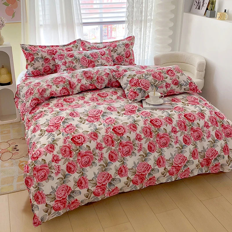 A floral printed duvet cover set featuring pink roses and green leaves on a white background.