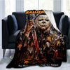 A dark horror themed throw blanket featuring a menacing figure resembling Michael Myers and autumn leaves.
