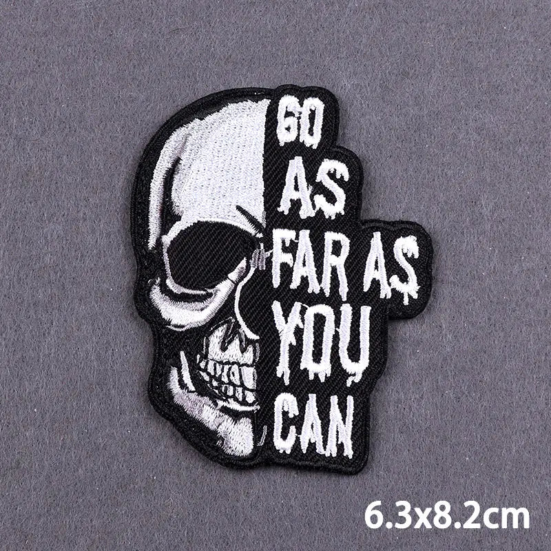 Black embroidered skull iron-on patch with text that reads Go as far as you can