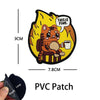 An embroidered patch featuring a cartoon orange cat drinking from a mug with the text This is fine.
